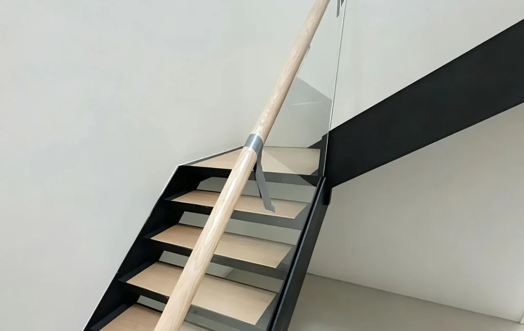 Custom steel stringer stairs with solid oak treads and glass balustrade, Melbourne project