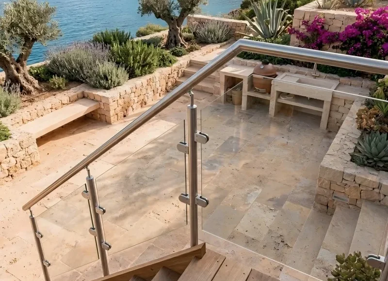 Stainless steel post glass railing system on stone garden stairs